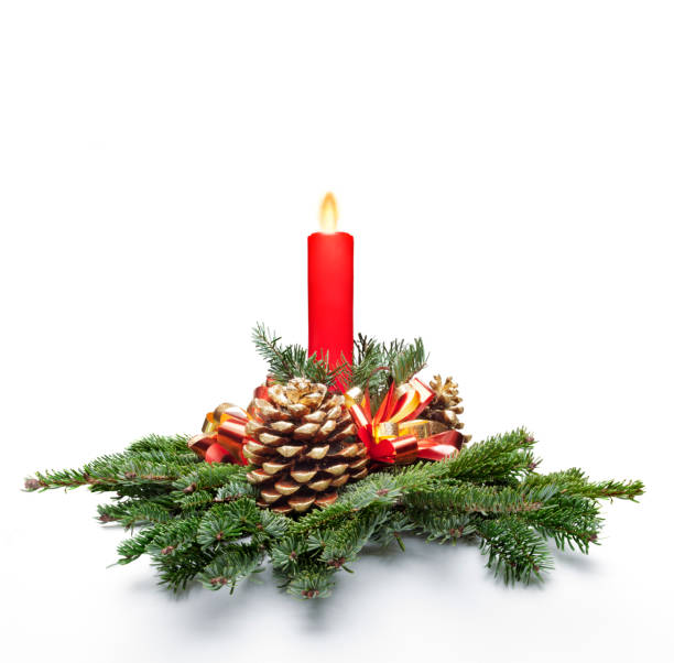 Chritmas decoration Christmas centerpiece decoration with a red color candle lit and fir tree leaves. White background. centerpiece stock pictures, royalty-free photos & images