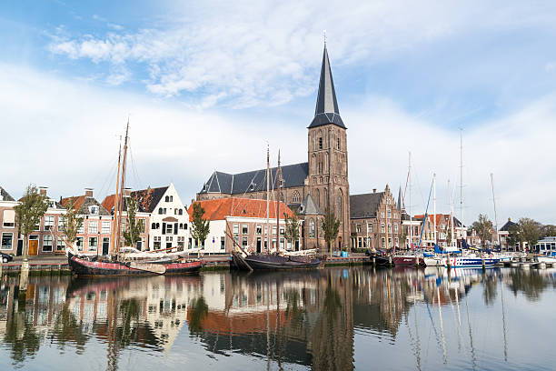 Church and boats in south harbour canal of Harlingen, Netherland stock photo