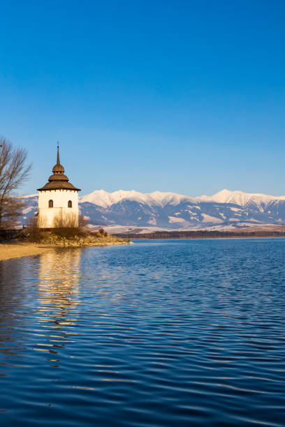 church of virgin mary in havranok and lake liptovska mara, district liptovsky mikulas, slovakia - mary mara imagens e fotografias de stock