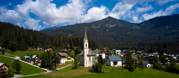 Church on top of hill near beautiful mountains view stock photo