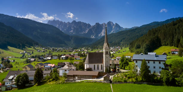 Church on top of hill near beautiful mountains view stock photo