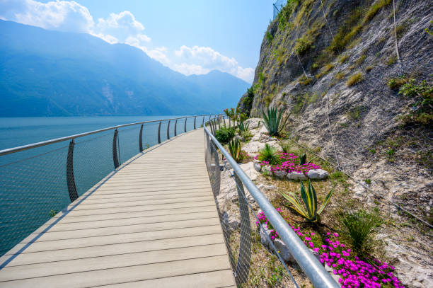 "Ciclopista del Garda" - Bicycle road and foot path over Garda lake with beautiful landscape scenery at Limone Sul Garda - travel destination in Brescia, Italy stock photo