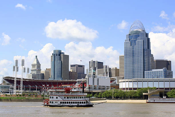 Cincinnati Riverfront Skyline The Ohio River on a sunny day with the skyline of the city of Cincinnati in the background.  A steamboat sails by in the foreground. Shot in 2011 and includes the Queen City Tower, completed in 2011. cincinnati stock pictures, royalty-free photos & images