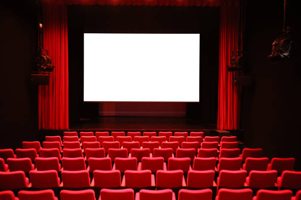 Cinema with Red Seats and Blank Screen Empty cinema room with red seats and a blank white screen movie theater stock pictures, royalty-free photos & images