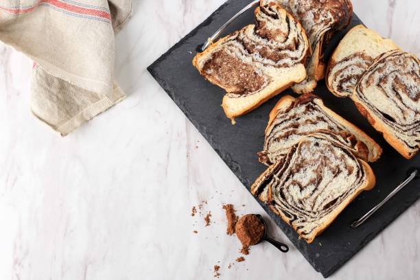 Cinnamon Babka or Brioche Bread. Swirl bread, homemade pastry for breakfast, white background, close up. stock photo