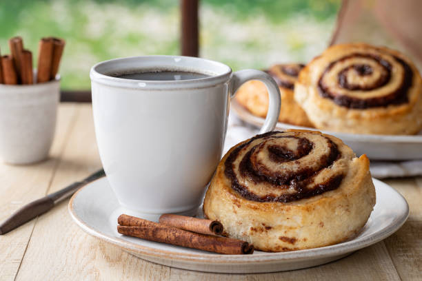 Cinnamon roll and cup of coffee stock photo