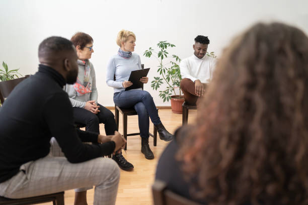 Circle for support A group of people holding a mental health meeting in a white modern mental health facility drug rehab stock pictures, royalty-free photos & images