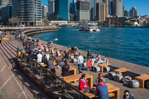 Circular Quay Sydney cityscape with people relaxing at waterfront restaurants stock photo