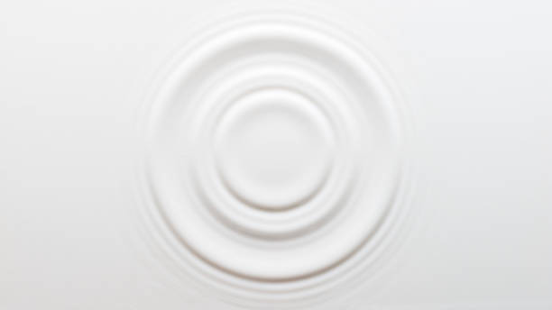 Circular ripples on the surface of the milk stock photo