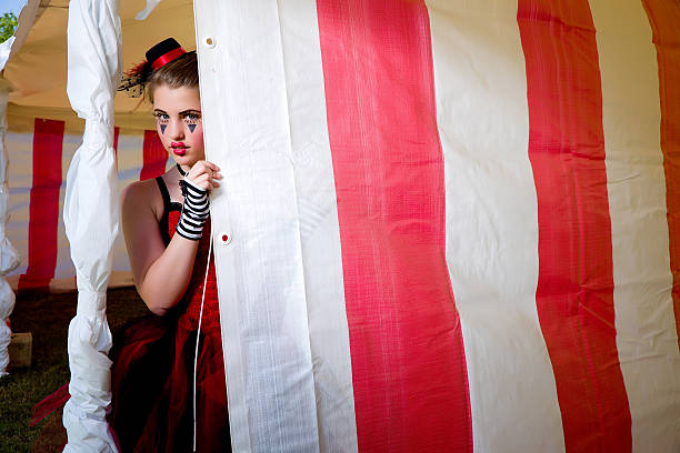 Circus Jester Hiding behind Tent Flap stock photo