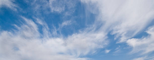 Cirrus Clouds in a Blue Sky Cirrus clouds appear in a blue sky over Tule Lake National Wildlife Refuge, California, USA. jeff goulden panoramic stock pictures, royalty-free photos & images