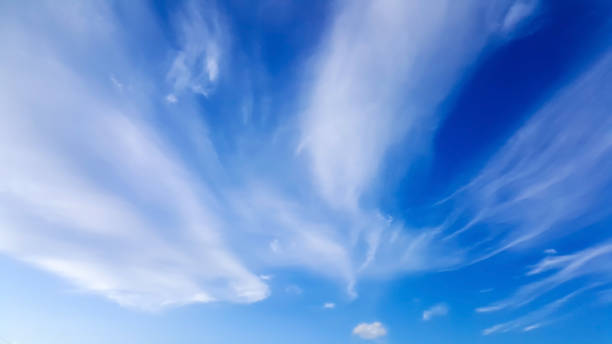 Cirrus sky background High white wispy cirrus clouds with cirri-stratus in the blue sky wispy stock pictures, royalty-free photos & images