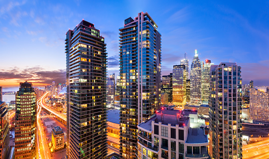 Long exposure panoramic photo of downtown Toronto cityscape and condominium towers at sunset and twilight