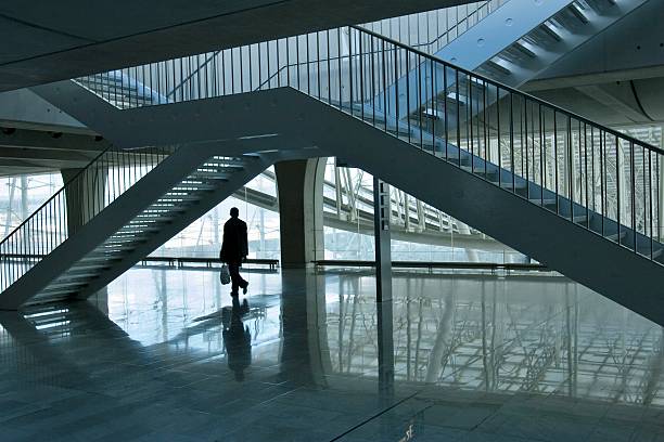 City life : man walking under stairs in a modern building. stock photo