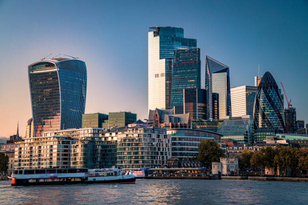 City of London's financial district lit by the rays of the setting Sun as seen from London City Hall - creative stock image stock photo