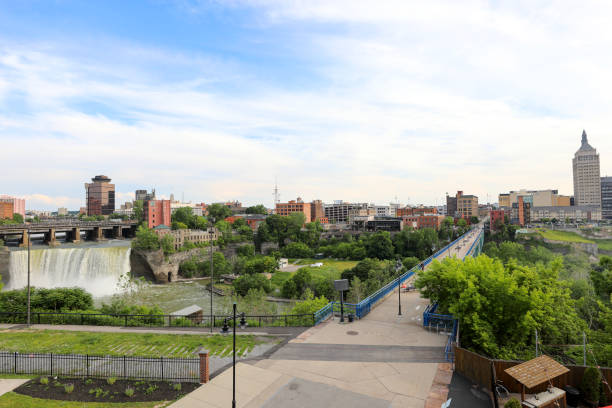 City of Rochester, NY skyline with High Falls and the Ponte de Rennes walkway stock photo