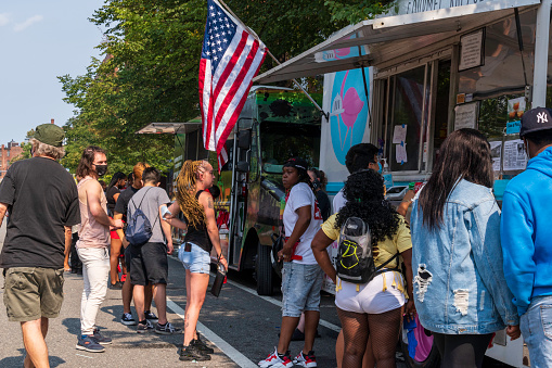 27th annual Cambridge Caribbean Festival. Cambridge, MA 2021 during Covid-19 People get food at a food truck