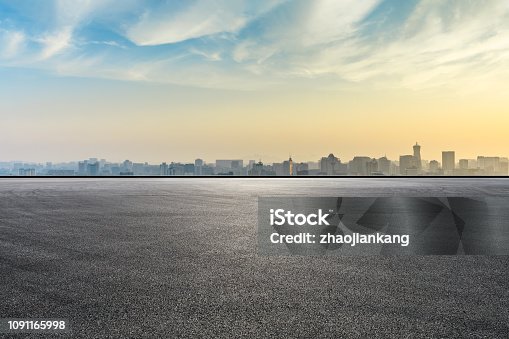 istock City skyline and buildings with empty asphalt road at sunrise 1091165998