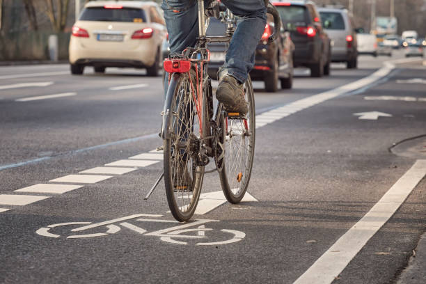 city_cyclist cycling on a bicycle lane in the city bicycle stock pictures, royalty-free photos & images