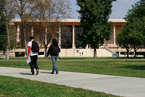 Class Walk two students male and female on college campus stock photo