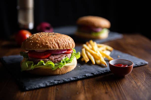 classic burger with fries, horizontal classic burger with fries, horizontal chiaroscuro stock pictures, royalty-free photos & images