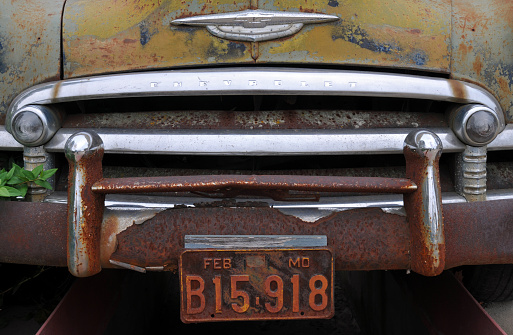 Cuba, MO, USA, Oct. 3, 2019: Detail of the front end of an old rusting Chevrolet automobile parked at the Wagon Wheel Motel, a historic landmark on Route 66 in Cuba.