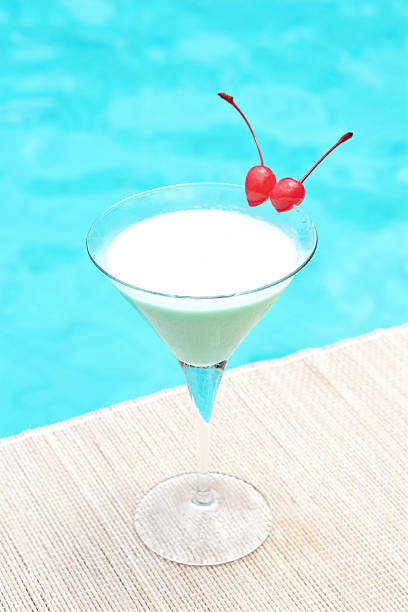 Classic grasshoper cocktail near waterpool on the mat stock photo