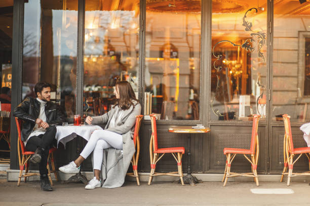 A classic Parisian cafe Young couple is having lunch at outdoors cafe. french culture stock pictures, royalty-free photos & images