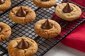 istock Classic Peanut Butter Blossom Cookies on a Kitchen Counter 1284787340