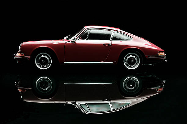Classic Porsche 911 Model Beaconsfield, UK - October 7, 2015: A 1:18 scale model of a 1964 Porsche 911 made by Auto Art, set against a solid black background. porsche 911 stock pictures, royalty-free photos & images