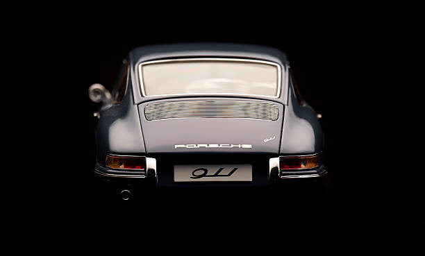 Classic Porsche 911 Model Rear View Beaconsfield, UK - February 22, 2016: A 1:18 scale model of a 1964 Porsche 911 made by Auto Art, set against a solid black background. Low key image of the back end of the car. porsche 911 stock pictures, royalty-free photos & images