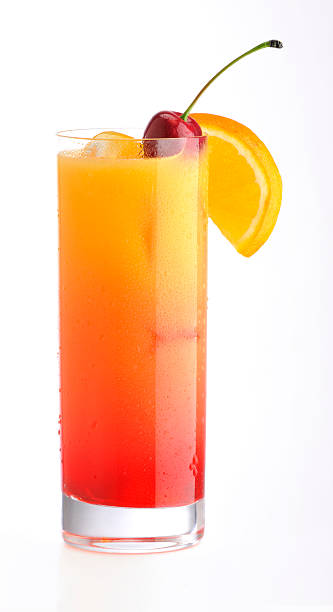 Classic Tequila Sunrise cocktail with cherry & orange slice on ice Classic tequila sunrise cocktail in contemporary highball glass; iced cold with condensation; on white highball glass stock pictures, royalty-free photos & images