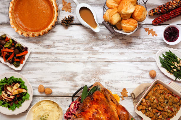 Classic Thanksgiving turkey dinner. Top down view frame on a rustic white wood background. Classic Thanksgiving turkey dinner. Top down view frame on a rustic white wood background with copy space. Turkey, mashed potatoes, dressing, pumpkin pie and sides. thanksgiving holiday stock pictures, royalty-free photos & images