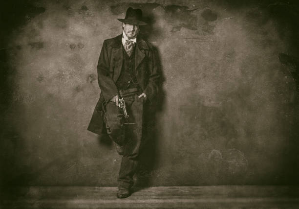 Classic wet plate photo of mysterious vintage 1900 western man standing against wall. stock photo