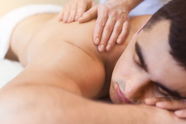 Classical body massage at physiotherapist office Body massage at physiotherapist office. Handsome man getting professional spine and back treatment. Rehabilitation, medical massage and manual therapy concept massaging photos stock pictures, royalty-free photos & images