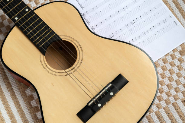 Classical guitar together with a sheet music stock photo