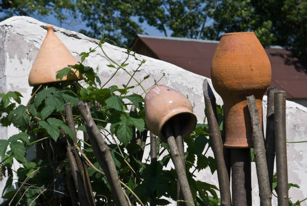 Clay pots on a wattle fence stock photo