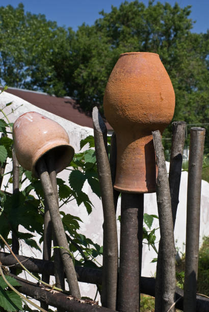 Clay pots on a wattle fence stock photo
