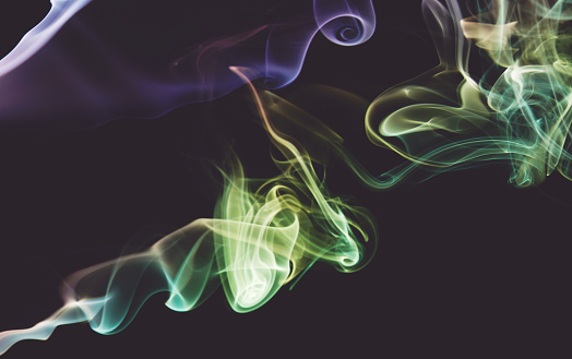 Clean smooth colorful smoke abstract curles on dark wallpaper