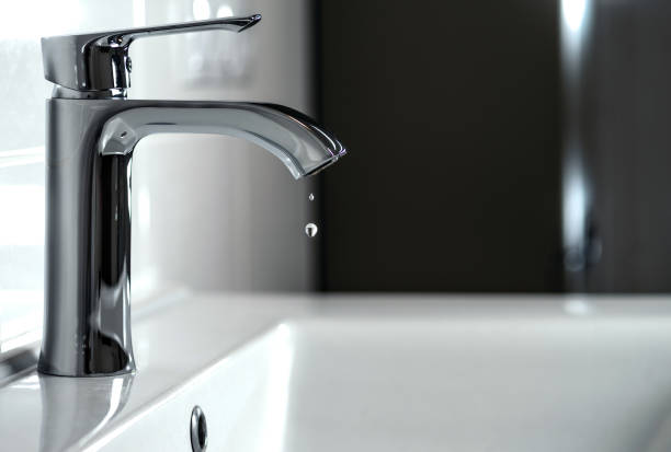Clean water is dripping from the faucet stock photo
