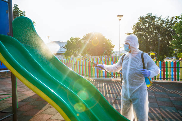 Cleaning and disinfecting slides in the playground park due to Coronavirus pandemic Cleaning and disinfecting slides in the playground park due to Coronavirus pandemic. Service staff doing disinfection. New normal. playground cleaning stock pictures, royalty-free photos & images