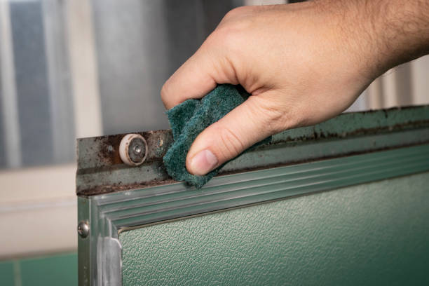 Cleaning and refurbishing vintage sliding shower door stock photo
