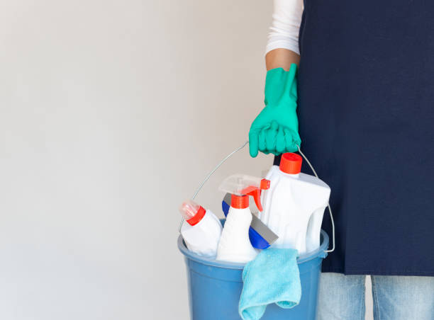Cleaning Lady Holding Cleaning Bucket Woman holding cleaning products with glove. cleaning service stock pictures, royalty-free photos & images
