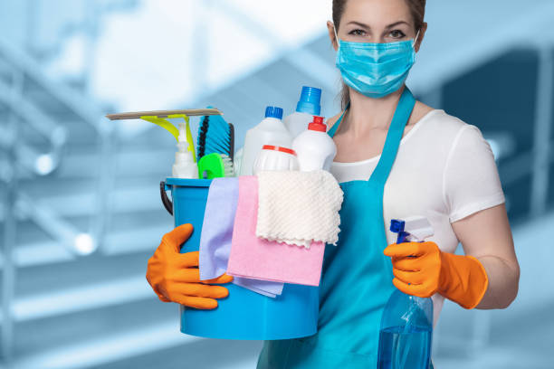 Cleaning lady with tool in cleaning in mask . Cleaning lady with tool in cleaning in mask on a blurred background. housework stock pictures, royalty-free photos & images