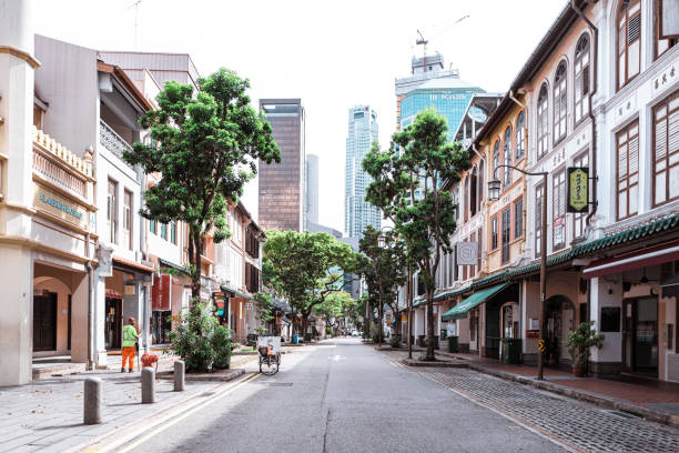 A cleaning man on empty street in Singapore stock photo