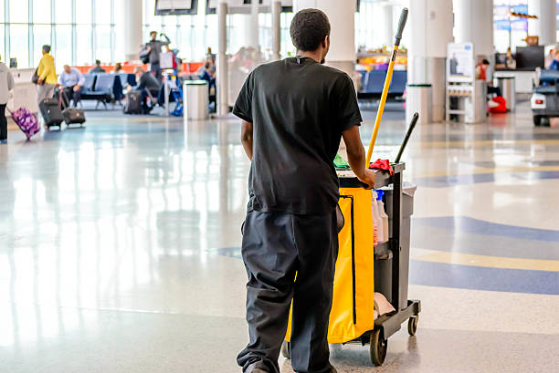 cleaning man pushing cart in an airport Houston, Texas, USA - September 14, 2014: IAH, Houston Intercontinental Airport, Houston, TX, USA - cleaning man pushing cart in an airport airport cleaning stock pictures, royalty-free photos & images