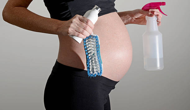 cleaning products, household chores and pregnancy stock photo