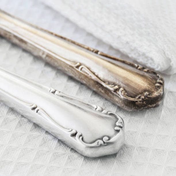 Cleaning tarnished silverware comparison stock photo