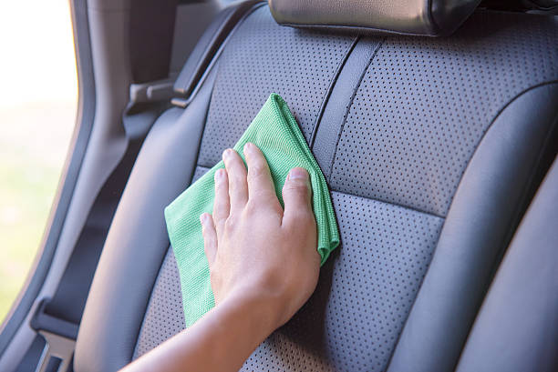 Cleaning the car interior Hand cleaning the car interior with green microfiber cloth seat stock pictures, royalty-free photos & images