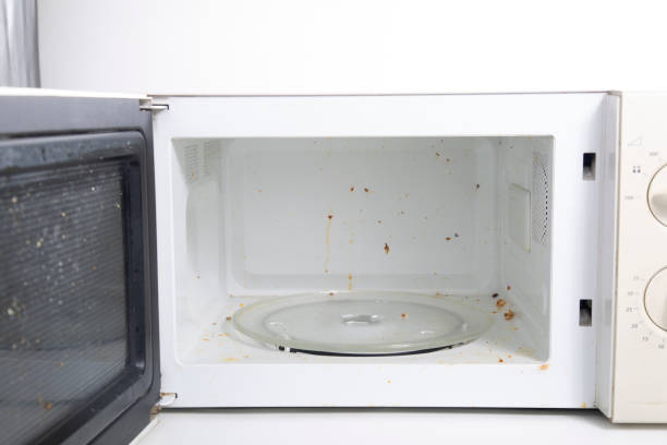 Cleaning the microwave oven stock photo